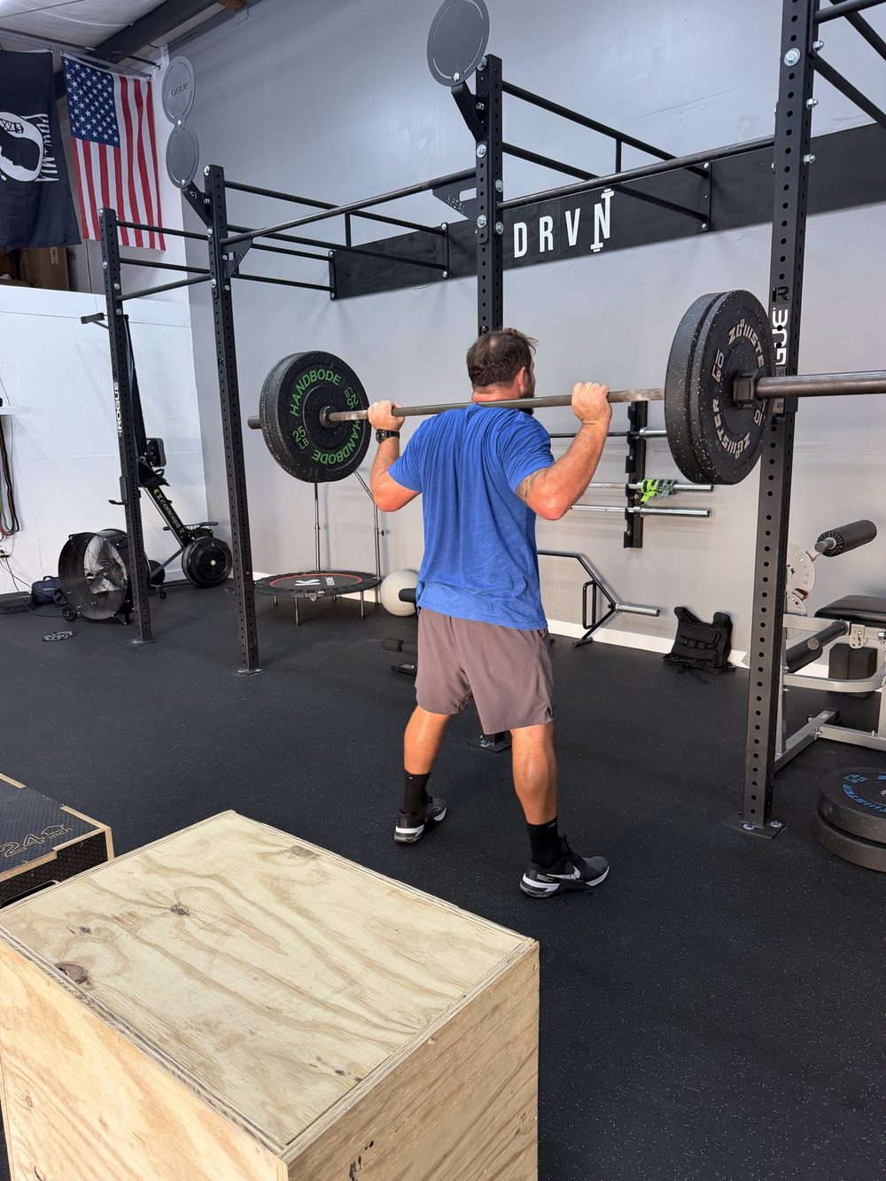 Client back squatting during a personal training session at DRVN